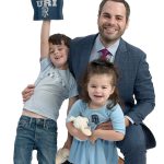 the prop John Olerio poses with his son, Anthony, 5, and daughter, Lianna, 2, both of whom are holding University of Rhode Island apparel.