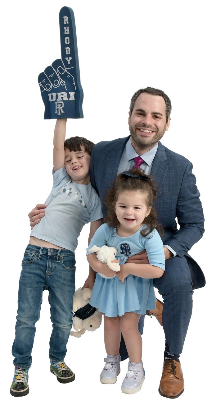 the prop John Olerio poses with his son, Anthony, 5, and daughter, Lianna, 2, both of whom are holding University of Rhode Island apparel. the prop John Olerio poses with his son, Anthony, 5, and daughter, Lianna, 2, both of whom are holding University of Rhode Island apparel.