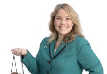 Jennifer Rousseau the prop Jennifer Rousseau holds a pair of hiking boots, representing one of her favorite pastimes and symbolizing the journey of entrepreneurship.