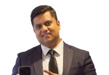 the prop Balavignesh Thirumalainambi holds a phone, which is both a personal device and, he says, a powerful tool for transforming health care. “I’m excited about how mobile technology is being leveraged at Care New England to enhance patient care and streamline operations,” he said.