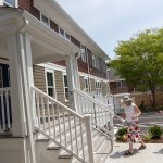 NEW DIGS: Invited dignitaries and officials tour 2 Hammett Court in Jamestown in June. The housing project is unique because it is considered affordable housing that is also constructed to be accessible to those with disabilities.  COURTESY LOOKING UPWARDS INC.