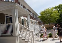 NEW DIGS: Invited dignitaries and officials tour 2 Hammett Court in Jamestown in June. The housing project is unique because it is considered affordable housing that is also constructed to be accessible to those with disabilities.  COURTESY LOOKING UPWARDS INC.