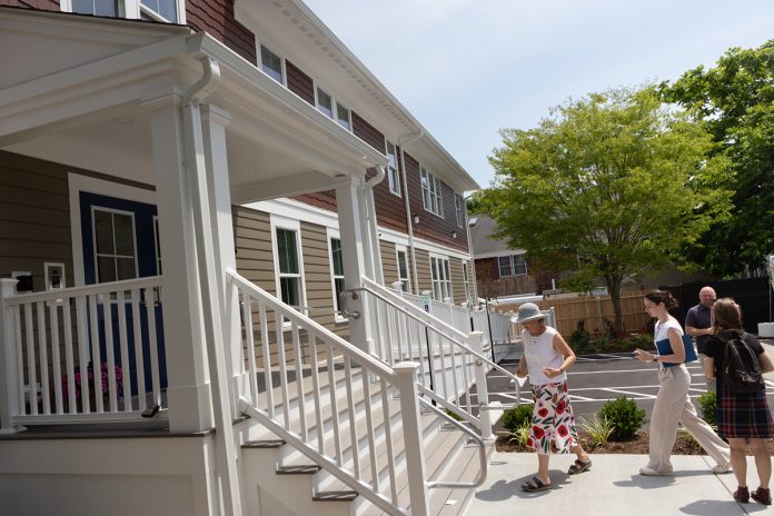 NEW DIGS: Invited dignitaries and officials tour 2 Hammett Court in Jamestown in June. The housing project is unique because it is considered affordable housing that is also constructed to be accessible to those with disabilities.  COURTESY LOOKING UPWARDS INC.