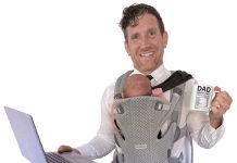 the prop Robert Ellsworth holds a laptop, a dad mug and his infant daughter. “Just a typical day as a remote working dad!” he said. 
