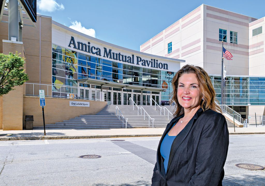 GAME ON: Kristen Adamo, CEO and president of the Providence Warwick Convention & Visitor Bureau, stands in front of the Amica Mutual Pavilion in Providence, a key part of the city’s ability to attract sporting events and conventions.  PBN PHOTO/MICHAEL SALERNO