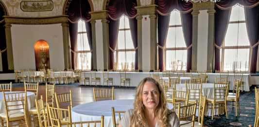 ADAMANT ADVICE: Charlene DeLuca, wedding planner and founder of Just a Girl Events LLC in Providence, recommends that bridal parties pay for event liability insurance coverage for their wedding, even if the venue doesn’t require it. She is pictured at the Graduate by Hilton in Providence. PBN PHOTO/MICHAEL SALERNO