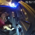Report: Assistant AG placed on unpaid leave for 6 months after altercation with Newport police IN AN IMAGE taken from police body camera footage, Rhode Island Special Assistant Attorney General Devon Flanagan sits in a police cruiser following her arrest on Aug. 14. / NEWPORT POLICE DEPARTMENT VIA THE ASSOCIATED PRESS