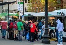 BUS RIDERS LINE UP recently at Kennedy Plaza in Providence to board the R.I. Public Transit Authority bus on Route 31 to Cranston Street. Route 31 is one of the route that will be see reduced frequency under service cuts. PBN FILE PHOTO/MICHAEL SALERNO