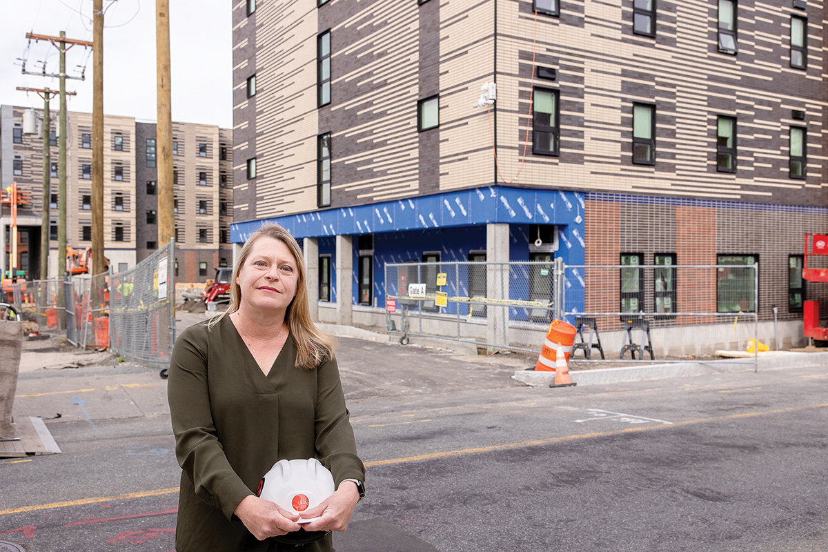 LOOKING AHEAD: Christine West, co-owner and principal at Providence-based KITE Architects Inc., visits the 176-unit Summer Street Apartments, an affordable housing project designed by KITE for Crossroads Rhode Island. West is concerned about clients that rely on funding that the federal government has been cutting. PBN PHOTO/TRACY JENKINS