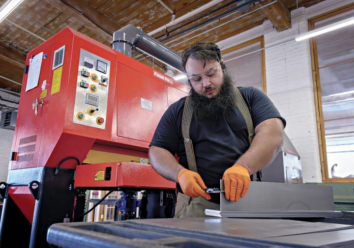 REBOUND: Ward’s Manufacturing LLC in Warren earlier this year lost business due to increased tariffs on steel and aluminum. It’s since rebounded by adding new customers. Pictured is technician Noel Laflamme.  PBN FILE PHOTO/­MICHAEL SALERNO  