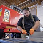 CRACKS IN THE METTLE | PBN survey: R.I. businesses remain resilient, but doubts rising about future STEELY GAZE: Noel Laflamme, a technician at metal fabricator Ward’s Manufacturing LLC in Warren, measures the thickness of a steel plate as he prepares for a job in the workshop.
PBN PHOTO/MICHAEL SALERNO