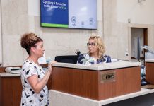 KEEPING TABS: Erica Harrold,  left, Centreville Bank’s assistant branch manager, speaks with banker Missy Minor at the  financial institution’s West Warwick location.  PBN PHOTO/TRACY JENKINS