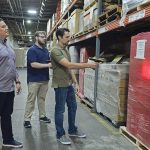 STORAGE SPACE: From left, Dean Warehouse Services Inc. Information Technology Director Cesar Ramirez, IT support technician Aiden Runk and System Administrator Jeremy Venditto work with the system they’ve developed to organize and locate stored items at the company’s Cumberland facility. PBN PHOTO/ELIZABETH GRAHAM