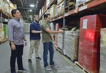 STORAGE SPACE: From left, Dean Warehouse Services Inc. Information Technology Director Cesar Ramirez, IT support technician Aiden Runk and System Administrator Jeremy Venditto work with the system they’ve developed to organize and locate stored items at the company’s Cumberland facility. PBN PHOTO/ELIZABETH GRAHAM