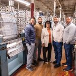 Meet the Makers: DaRosas weaving an impactful legacy in Pawtucket FAMILY TIES: North East East Knitting Inc. co-founder and President Rosalie DaRosa, middle, is surrounded by, from left, her son Michael DaRosa; her grandson Marcus DaRosa, who now oversees the business; and her sons Alex and Eric DaRosa at the company’s manufacturing facility in Pawtucket.
PBN PHOTO/TRACY JENKINS