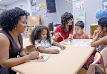 FAMILY ATMOSPHERE: Mery Polanco, left, owner and director of Nery’s Land Learning Center, and teaching assistant Felipa Ponte, third from right, work with kids at the day care center in Pawtucket. PBN PHOTO/MICHAEL SALERNO