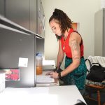 PAPERWORK: Rivka Reynolds, a peer recovery counselor with Thrive Behavioral Health Inc., fills out some paperwork in her organization’s West Warwick office. PBN PHOTO/PAUL SPETRINI