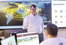 TRAINING GROUND: Douglas S. Alexander, director of the Institute for Cybersecurity & Emerging Technologies at Rhode Island College, speaks with RIC senior Miled Kalbourji in the institute’s new cyber range classroom. COURTESY RHODE ISLAND COLLEGE