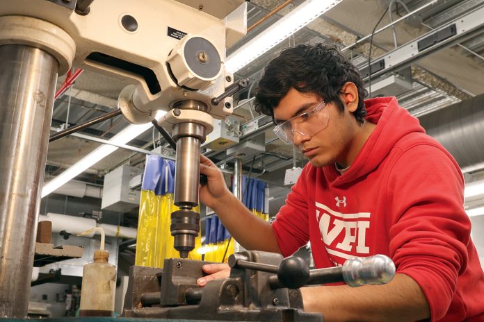 DRILLING DOWN: Mazinho Palencia, a Community College of Rhode Island graduate, works on a drill press in the school’s ­Advanced Manufacturing Lab in 2024. COURTESY COMMUNITY COLLEGE OF RHODE ISLAND
