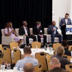 Summit: Businesses should ‘create a sandbox’ for AI experimentation ‘JUST A TOOL’: Donovan Brady, seated at far right, speaks during a panel discussion at Providence Business News’ Cybersecurity, AI & Tech Summit on Oct. 9. Brady and other panelists say artificial intelligence is creating opportunities for business. Also on the panel are, from left, Joyce Ofili, Amgen Inc. information systems specialist and business systems analyst; Arnell Milhouse, yconic co-founder and CEO; and Tim Henry, professor in Rhode Island College’s Computer Science and Information Technology Department. Moderating is Christopher Parisi, standing, founder of the marketing firm Trailblaze Inc.
PBN PHOTO/MIKE SKORSKI