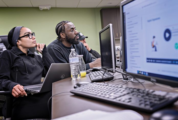 SPECIALIZED TRAINING: Marianny Rosario, left, and Malcolm Williams, both of Providence, participate in a cyber training class at Rhode Island College’s Institute for Cybersecurity & Emerging Technologies, which opened in November 2023 and was supported by $73 million in voter-approved bond funding. PBN PHOTO/MICHAEL SALERNO