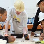 TRAINING: Quiana Ferguson, left, and Glendale Perez, center, students in a Building Futures pre-apprenticeship class that was held earlier this year from May 5 to June 6, work with Building Futures training team instructor Brook Swanson, second from right, on an exercise designed to introduce techniques used by millwrights. Pictured at right foreground is an unidentified student. COURTESY BUILDING FUTURES