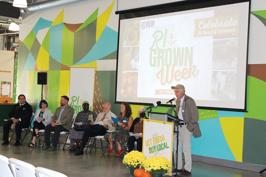 GROWING INDUSTRY: Ken Ayars, chief of agriculture and forestry for the R.I. Department of Environmental Management, speaks during RI Grown Day at Farm Fresh Rhode Island on Oct. 6. Seated, from left, are Bryan Jones, president of the Future Farmers of America Rhode Island chapter; Melissa Cherney, CEO of the Rhode Island Community Food Bank; Farm Fresh R.I. Executive Director Jesse Rye; Georgina Sarpong, director of food strategy at R.I. Commerce Corp.; DEM Director Terry Gray; and state legislators Rep. Teresa Tanzi, D-Narragansett, and Sen. V. Susan Sosnowski, D-South Kingstown.  COURTESY R.I. DEPARTMENT OF ENVIRONMENTAL MANAGEMENT