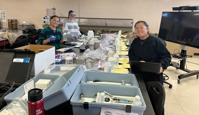 TESTING: Students Ashlee Lewandoski, left, Bridget Finnerty and Jacqui Pijnenburg in professor of engineering Janet Baldwin’s class at Roger Williams University test water samples from a coastal area in Warren to determine the extent of saltwater intrusion. COURTESY JANET BALDWIN