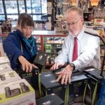 ANOTHER WAY?: Arnold Bromberg, right, former co-owner of Benny's Inc. and the grandson of the chain's founder, helps a customer at the Providence store in 2016. The family-owned business closed the following year, in part because there was not another generation of the family ready to take over. Lt. Gov. Sabina Matos says employee ownership might have offered another solution. / PBN FILE PHOTO/MICHAEL SALERNO