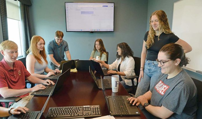 YOUTH MOVEMENT: A group of interns works together during a meeting at Falvey Insurance Group in North Kingstown. In addition to internships, the agency has launched an underwriter training program and is looking to start apprenticeships. PBN PHOTO/ELIZABETH GRAHAM