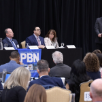 ‘We are in crisis’: PBN summit highlights glaring gaps in affordable, accessible health care DR. EDWARD MCGOOKIN, third from the left, speaks during a panel discussion at Providence Business News’ Fall Health Care Summit: Shaping the Future of Care on Thursday. McGookin is chief of primary care at Brown Health Medical Group Primary Care. With him during the first of two panel discussions are, from left, Victoria Williams, assistant professor of health care administration at Rhode Island College; Dr. Roger Mitty, president and chief operating officer of Care New England Medical Group; and Sen. Pamela Lauria, a nurse practitioner. Moderating is PBN Editor Michael Mello, standing. / PBN PHOTO/MIKE SKORSKI