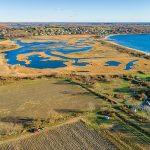 Shortage of planners impeding municipalities WITHOUT A PLANNER: Some towns, such as Tiverton, have gone years without a full-time town planner as they reckon with a housing crisis, other evolving infrastructure issues and new developments. For instance, in 2022, this undeveloped 12-acre Tiverton property was sold for $1.2 million. The new owner has said he has no plans for development.
COURTESY MOTT & CHACE SOTHEBY’S INTERNATIONAL REALTY