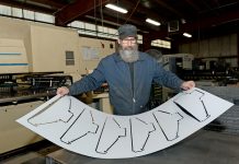 Renova Lighting Systems prioritizes sustainable and American-made lighting fixtures SHINING BRIGHT: Richard Reynolds, fabrication supervisor at Renova Lighting Systems in Warwick, holds a sheet of protective coating for light fixtures.
PBN PHOTO/ELIZABETH GRAHAM