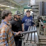 Tradition and technology make for a potent combination at Hawkins TEAM EFFORT: Troy Hawkins, left, and CJ Hawkins, center, both machinists, and Russell Walsh, shop manager, work on the manufacturing floor at Hawkins Machine Co. in Coventry.
PBN PHOTO/
ELIZABETH GRAHAM