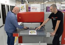 AstroNova credits rapid innovation and customer feedback with success ON A ROLL: Robert Brinkman, left, assembler technician, and Ben Daubenspeck, quality assurance engineer, work with an AJ 800 overprinter at electronics manufacturer AstroNova Inc. in West Warwick.
PBN PHOTO/ELIZABETH GRAHAM