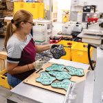 G-Form Engineers the Future of Flexible, High-Impact Gear UNIQUE PROTECTION: Niurka Fernandez, production lead at G-Form LLC, works on the factory floor at the company’s Providence facility, where it makes protective gear for athletes, as well as the military and law enforcement, using SmartFlex technology.
PBN PHOTO/TRACY JENKINS