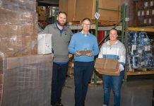 Inside the box: Atlantic Paper’s human touch fuels manufacturing success TAKING STOCK:
David Spencer, center, owner and CEO of Atlantic Paper & Supply, works
with JC Lebarron, left, part of the operations team, and Ashley Femino, sales coordinator, at the company’s Pawtucket facility.
PBN PHOTO/JOSH EDENBAUM