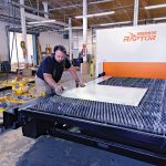 For Ward’s, survival of tariffs required complete overhaul of business FINAL TOUCHES: Manufacturing technician Noel Laflamme sets up a job on the laser cutter at metal fabricator Ward’s Manufacturing LLC in Warren.
PBN PHOTO/MICHAEL SALERNO