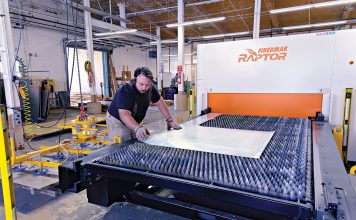 For Ward’s, survival of tariffs required complete overhaul of business FINAL TOUCHES: Manufacturing technician Noel Laflamme sets up a job on the laser cutter at metal fabricator Ward’s Manufacturing LLC in Warren.
PBN PHOTO/MICHAEL SALERNO