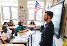 Entrepreneurship as a tool for equity FINANCE FUNDAMENTALS: Bryan Hoffman, a financial services certified professional with Gorra Financial Group, teaches financial literacy to a special education class at East Providence High School through Won Strategy, a program that introduces high school students to the fundamentals of business.
PBN PHOTO/MICHAEL SALERNO