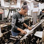 AN INTERESTING YARN: Victoria Teixeira, a barrier weaver at Murdock Webbing Co. in Central Falls, works the machinery on the production floor.  PBN PHOTO/MICHAEL SALERNO