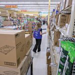WHAT’S IN STORE: Rachel Grady, an Ocean State Job Lot floor associate, stocks the shelves at the discount chain’s Johnston store. The company says its holiday hiring started in October this year.  PBN PHOTO/MICHAEL SALERNO 