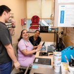 ALL SMILES: Medical assistants, from left, Dennis Tai, Jazmine de la Cruz and Lia Brito share a laugh at the Rhode Island Free Clinic in Providence, which has restructured its workforce to bring in new roles and create advancement opportunities. PBN PHOTO/TRACY JENKINS