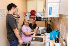 ALL SMILES: Medical assistants, from left, Dennis Tai, Jazmine de la Cruz and Lia Brito share a laugh at the Rhode Island Free Clinic in Providence, which has restructured its workforce to bring in new roles and create advancement opportunities. PBN PHOTO/TRACY JENKINS