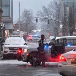 LAW ENFORCEMENT OFFICIALS continue to reroute traffic in the neighborhood surrouned the shooting scene at Brown University on Sunday. / AP PHOTO/STEVEN SENNE