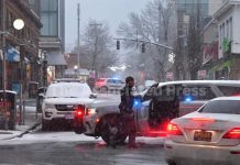 LAW ENFORCEMENT OFFICIALS continue to reroute traffic in the neighborhood surrouned the shooting scene at Brown University on Sunday. / AP PHOTO/STEVEN SENNE