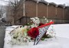 Authorities say they will release person of interest detained in Brown University shooting A BOUQUET OF FLOWERES rests on the snow on the Brown University campus on Sunday, not far from where the shooting took place the day before in Providence. PBN PHOTO/STEVEN SENNE