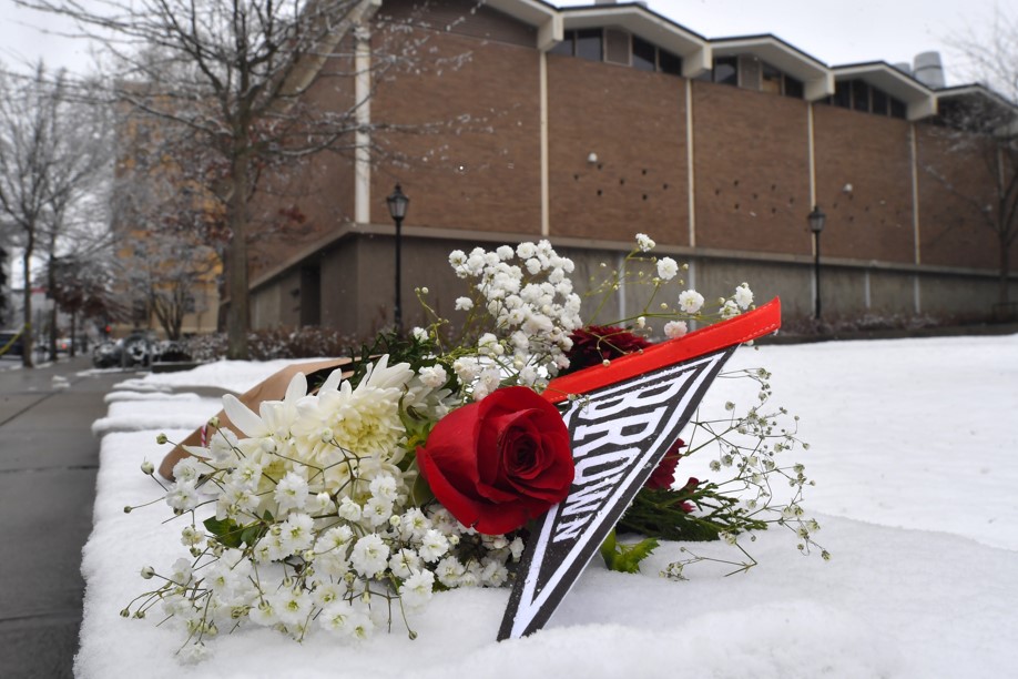 A BOUQUET OF FLOWERES rests on the snow on the Brown University campus on Sunday, not far from where the shooting took place the day before in Providence. PBN PHOTO/STEVEN SENNE