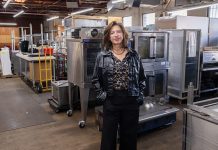 Demand only heating up for kitchen facilities GOT SOMETHING COOKING:
Lisa Raiola, founder and president of Hope & Main, stands among some of the kitchen equipment that will be put to use at the yet-to-be-completed new food business incubator, West End Kitchens, in Providence. It is set to open around June.
PBN PHOTO/TRACY JENKINS