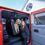 ALL ABOARD: Leslie Filippelli-­DiManna runs pet shuttle service The Doggie Waggin’ in Smithfield. She is pictured with Maverick, a 2-year-old golden retriever.  PBN PHOTO/MICHAEL SALERNO